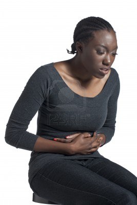 16963274-close-up-image-of-a-black-woman-with-stomach-ache-isolated-on-a-white-surface